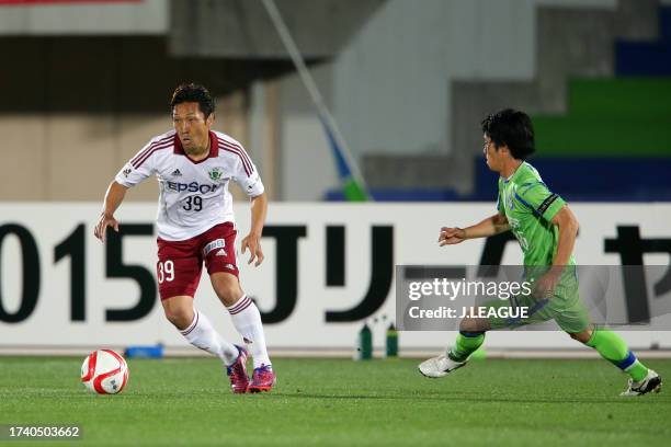 Yoshiro Abe of Matsumoto Yamaga controls the ball against Toshiki Ishikawa of Shonan Bellmare during the J.League Yamazaki Nabisco Cup Group A match...