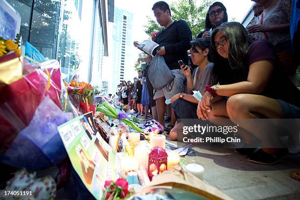 Fans pay Tribute at the Candle Light Vigil for Cory Monteith at the Fairmont Pacific Rim on July 19, 2013 in Vancouver, Canada.