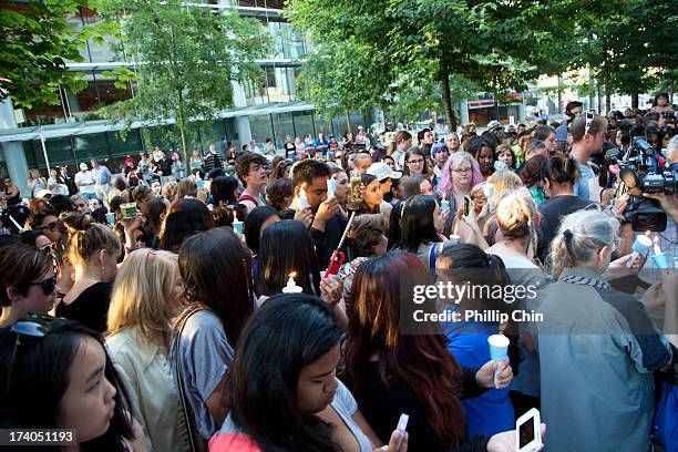 Fans pay Tribute at the Candle Light Vigil for Cory Monteith at the Fairmont Pacific Rim on July 19, 2013 in Vancouver, Canada.