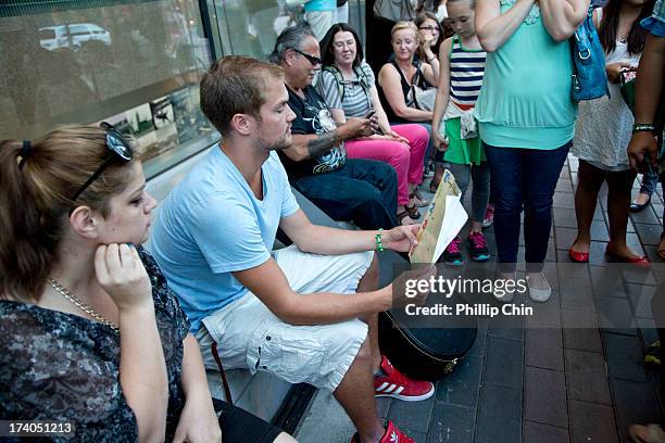 Fans pay Tribute at the Candle Light Vigil for Cory Monteith at the Fairmont Pacific Rim on July 19, 2013 in Vancouver, Canada.