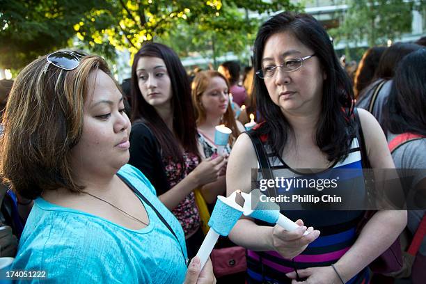 Fans pay Tribute at the Candle Light Vigil for Cory Monteith at the Fairmont Pacific Rim on July 19, 2013 in Vancouver, Canada.