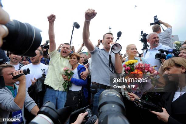 Russia's top opposition leader Alexei Navalny addresses supporters and journalists next to and his former colleague Pyotr Ofitserov upon his arrival...