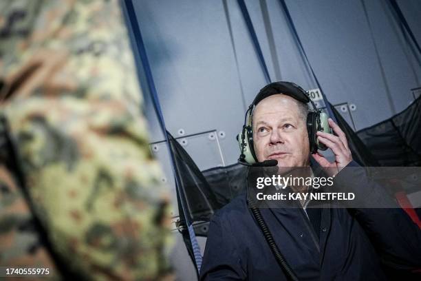 German Chancellor Olaf Scholz sits in an Airbus A400M of the German Air Force on October 23, 2023 in Berlin, bound to the military airport of...