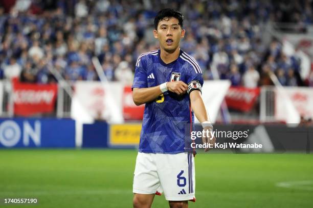 Wataru Endo of Japan adjusts the captain's armband during the international friendly match between Japan and Tunisia at Noevir Stadium Kobe on...