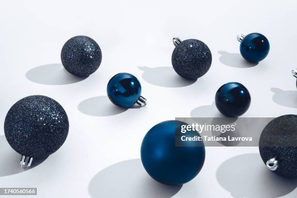 blue festive xmas tree toys pattern on white background with copy space for text or design elements. christmas baubles on table - knick knack stock pictures, royalty-free photos & images