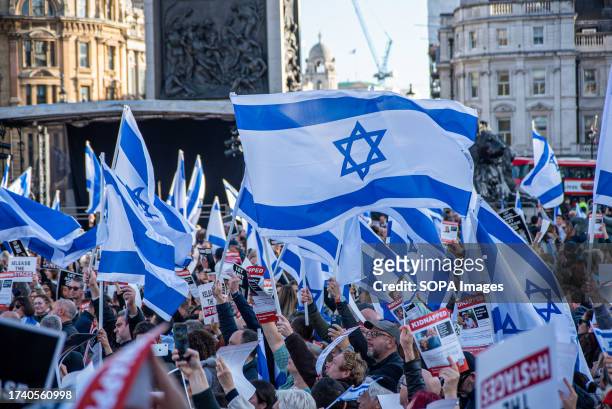 Protesters wave Israeli flags during the demonstration on the Trafalgar Square in London. In London's Trafalgar Square, thousands of demonstrators...