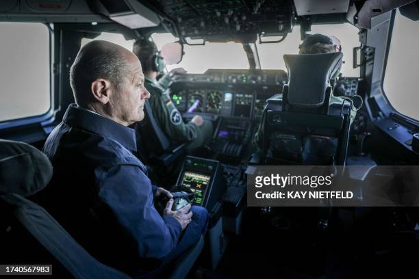 German Chancellor Olaf Scholz sits in the cockpit of an Airbus A400M of the German Air Force on October 23, 2023 in Berlin, bound to the military...