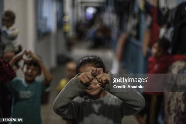 Children are seen at a United Nations Agency for Palestine Refugees school sheltering displaced Palestinians in Khan Yunis, Gaza on October 22, 2023.