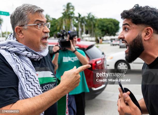 Pro-Palestinian activist, left, argues with a pro-Israel activist during a rally near the Torch of Friendship on Friday, Oct. 13 in downtown Miami,...