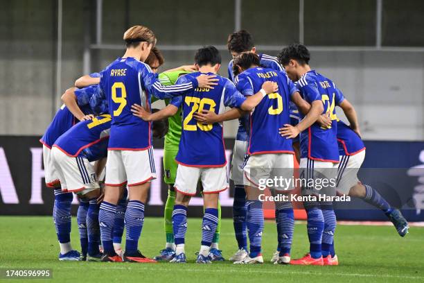 Japan players huddle before the second half during the international friendly match between Japan and Tunisia at Noevir Stadium Kobe on October 17,...