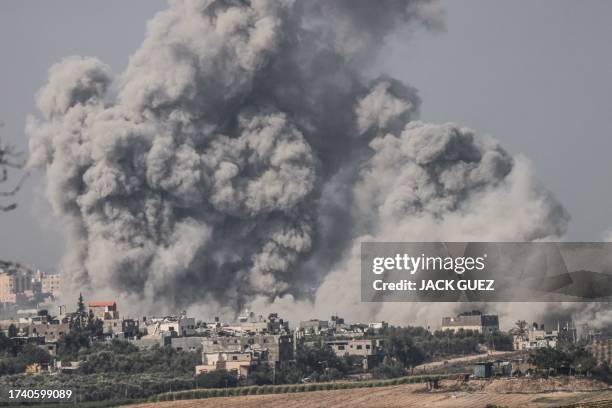 Graphic content / A picture taken from the southern Israeli city of Sderot on October 23 shows smoke ascending over the northern Gaza Strip following...