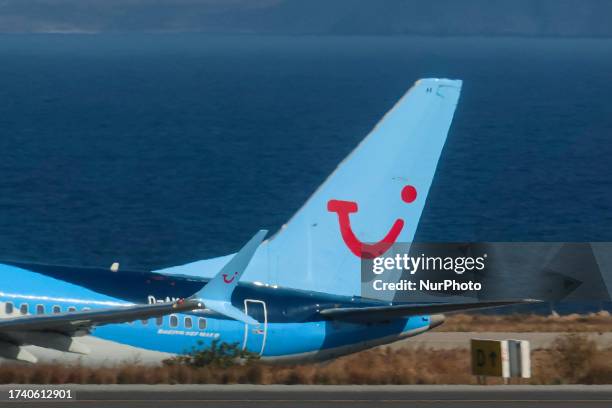 Close up at the tail of the airplane, the vertical stabilizer with TUI logo. TUIfly Boeing 737 MAX 8 aircraft seen during take off, rotation and...