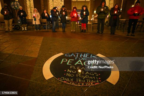 Edmontonians hold a 1-hour silent candlelight vigil outside Town Hall, braving -1°C temperatures, to call for peace and an end to the...