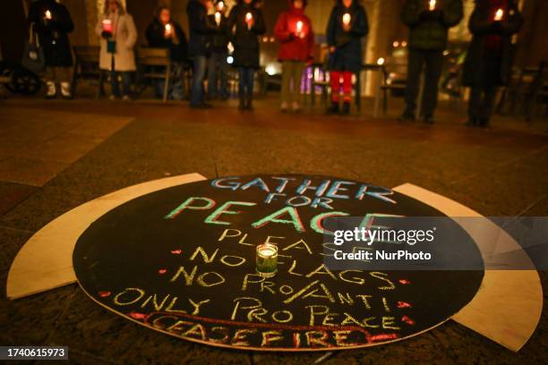 Edmontonians hold a 1-hour silent candlelight vigil outside Town Hall, braving -1°C temperatures, to call for peace and an end to the...