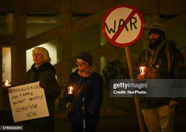 Edmontonians hold a 1-hour silent candlelight vigil outside Town Hall, braving -1°C temperatures, to call for peace and an end to the...