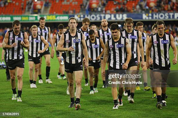 Nick Maxwell of the Magpies leads the team off after losing the round 17 AFL match between the Gold Coast Suns and the Collingwood Magpies at...