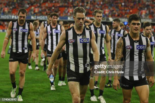 Nick Maxwell of the Magpies leads the team off after losing the round 17 AFL match between the Gold Coast Suns and the Collingwood Magpies at...