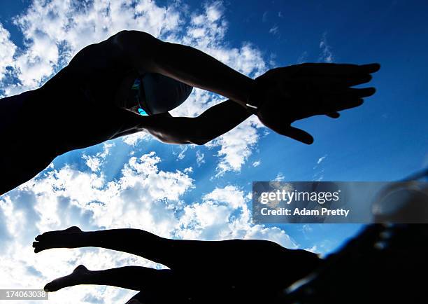 Competitors dive into the water at the start of the Open Water Swimming Women's 5k race on day one of the 15th FINA World Championships at Moll de la...