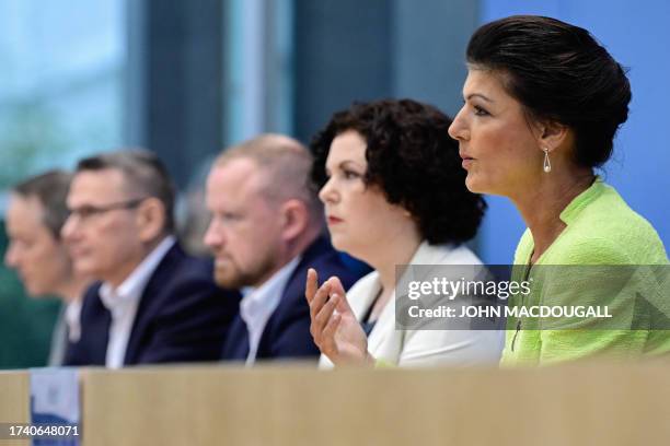 Sahra Wagenknecht , politician of Germany's left-wing Die Linke party, next to Amira Mohamed Ali and other supporters of her movement, addresses a...