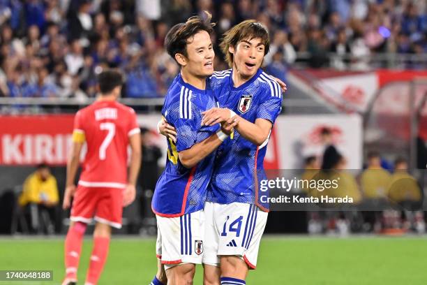 Junya Ito of Japan celebrates with teammate Takefusa Kubo after scoring his team's second goal during the international friendly match between Japan...