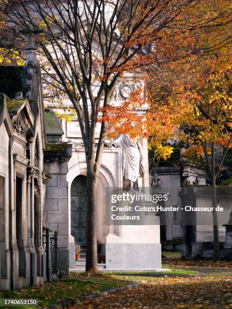 ancients chapels and funerary monuments with a tree in the colors of autumn at the pere lachaise cemetery - funeral background stock pictures, royalty-free photos & images