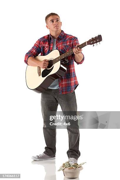 street musician playing a guitar - guitar isolated stock pictures, royalty-free photos & images