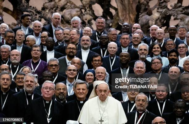 Pope Francis poses for a family photograph with the participants of the Synod of Bishops at the Paul VI Hall in Vatican on October 23, 2023. The...