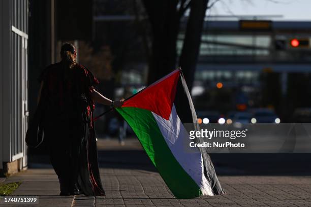 Pro-Palestinian supporter returns home after a 'Gaza Awareness' peaceful march at the University of Alberta, on October 20 in Edmonton, Alberta,...