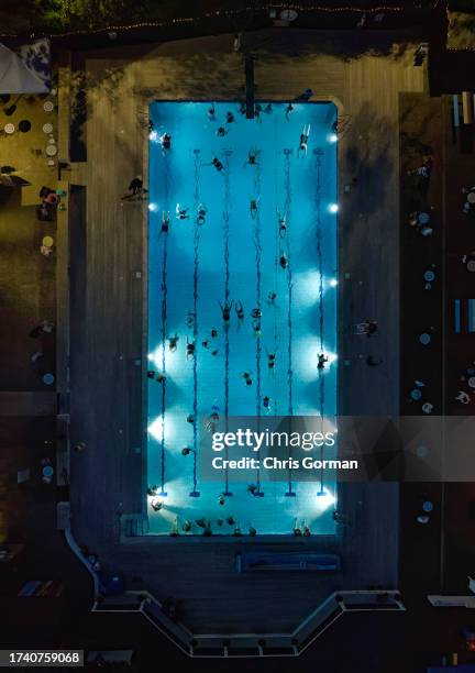 Swimmers at Petersfield Open Air Pool swim at night on August 17,2023 in Petersfield, England.