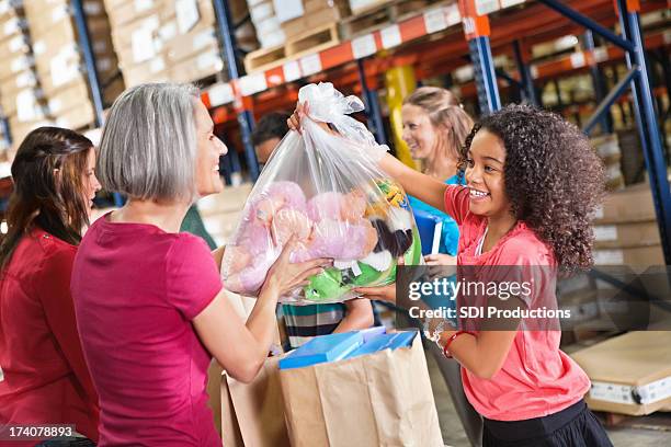 volunteers accepting toy clothing and food donations at charity drive - charity gala 2012 stock pictures, royalty-free photos & images