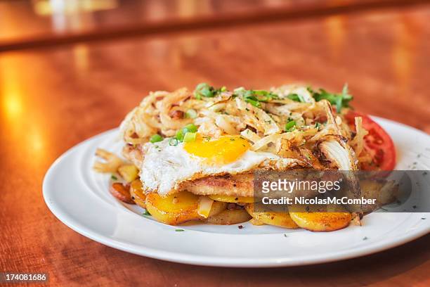 schnitzel with egg and fried onions - fried potato stock pictures, royalty-free photos & images