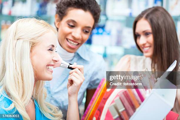 women shopping for make-up products - cosmetic testing store stock pictures, royalty-free photos & images