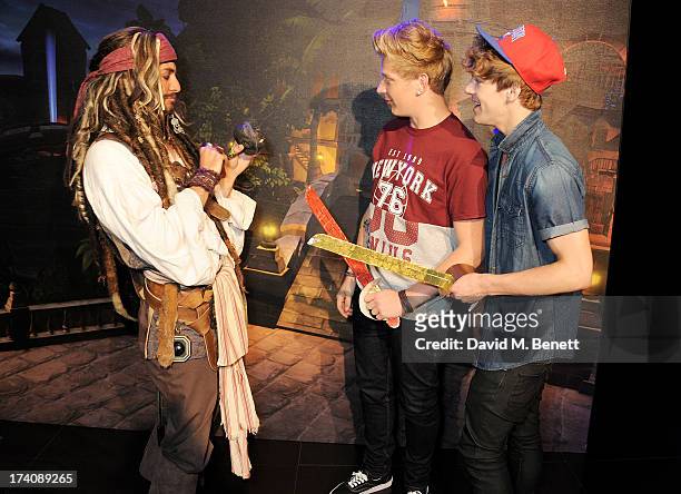 Greg West and Dan Ferrari-Lane of District 3 with Captain Jack Sparrow attend an exclusive launch event for upcoming videogame 'Disney Infinity',...