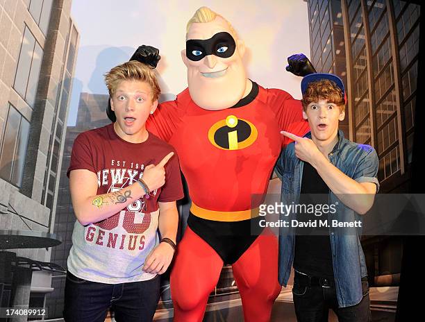 Greg West and Dan Ferrari-Lane of District 3 pose with Mr Incredible at an exclusive launch event for upcoming videogame 'Disney Infinity', released...