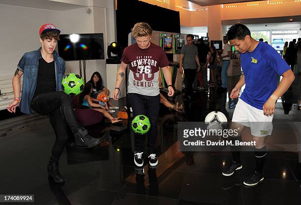 Dan Ferrari-Lane and Greg West of District 3 play football with Francis Vu at an exclusive launch event for upcoming videogame 'Disney Infinity',...