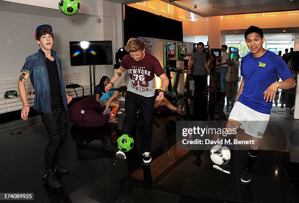 Dan Ferrari-Lane and Greg West of District 3 play football with Francis Vu at an exclusive launch event for upcoming videogame 'Disney Infinity',...