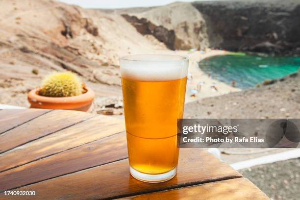 beer on the table, beach in the background - ale stock pictures, royalty-free photos & images