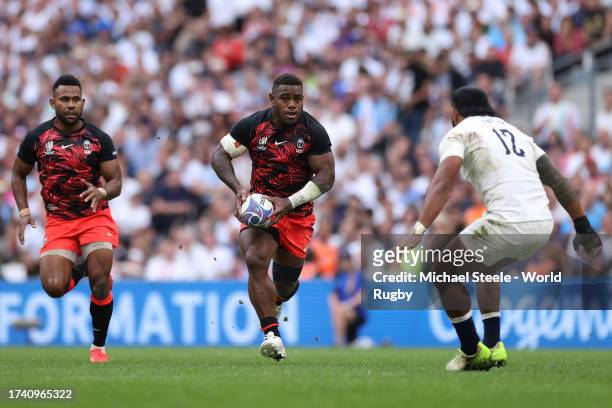Josua Tuisova of Fiji runs at Manu Tuilagi of England during the Rugby World Cup France 2023 Quarter Final match between England and Fiji at Stade...