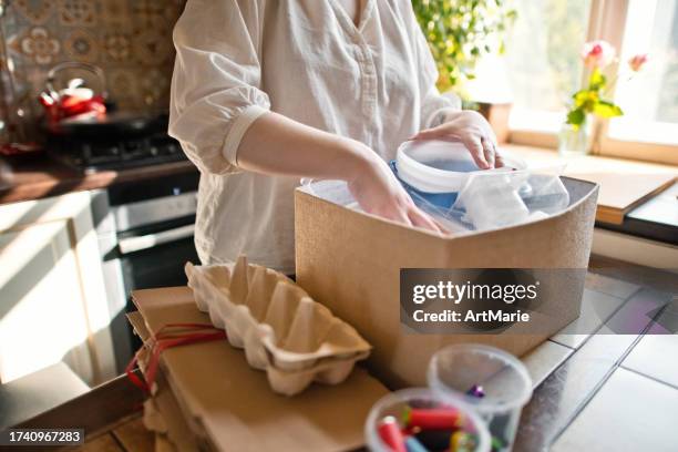 young woman sorting out waste at home . sustainable lifestyle and garbage recycling concept. - battery life stock pictures, royalty-free photos & images