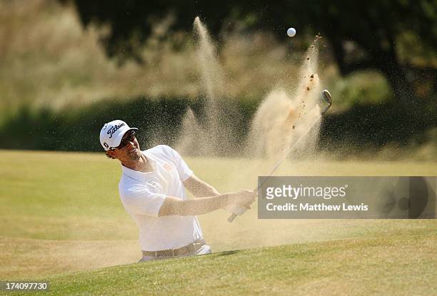 Adam Scott of Australia hits out of the bunker on the 2nd hole during the third round of the 142nd Open Championship at Muirfield on July 20, 2013 in...