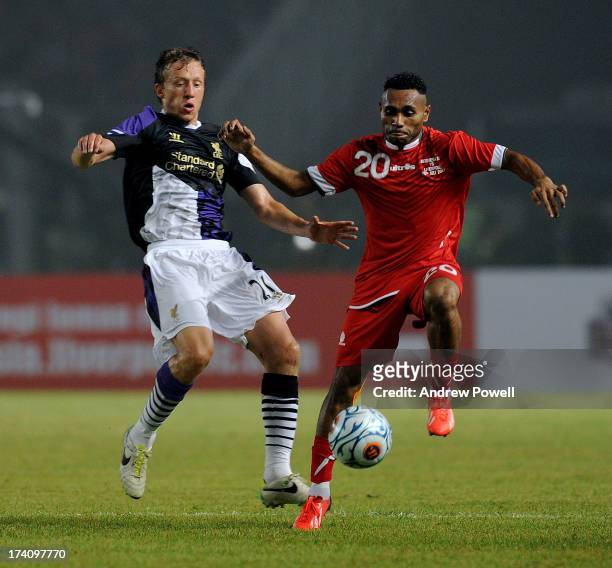 Lucas Leiva of Liverpool competes with Titus Bonay of Indonesia XI during the Pre Season match between Indonesia XI and Liverpool at Gelora Bug Karno...