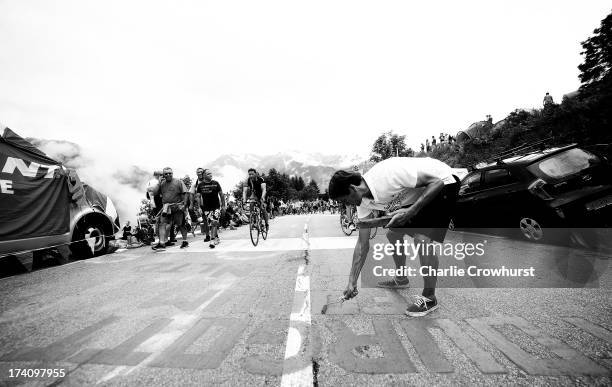 Spectator paints the road during stage eighteen of the 2013 Tour de France, a 172.5KM road stage from Gap to l'Alpe d'Huez, on July 18, 2013 in Alpe...