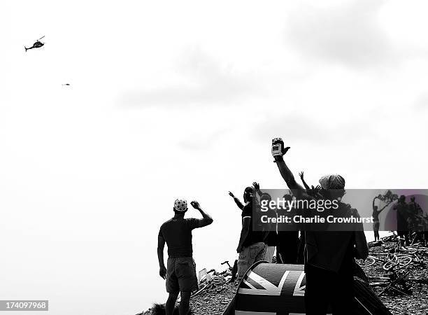 Spectators wave to the helicopter during stage fifteen of the 2013 Tour de France, a 242.5KM road stage from Givors to Mont Ventoux, on July 14, 2013...