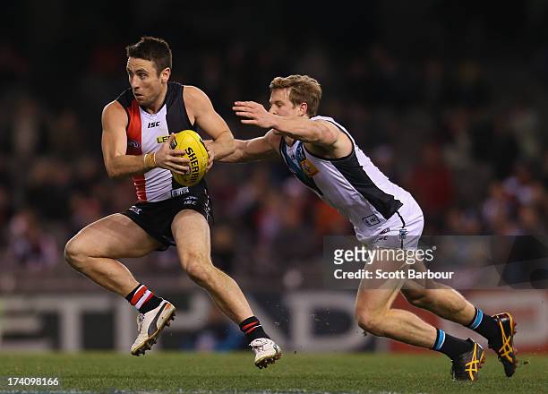 Stephen Milne of the Saints runs with the ball during the round 17 AFL match between the St Kilda Saints and Port Adelaide Power at Etihad Stadium on...