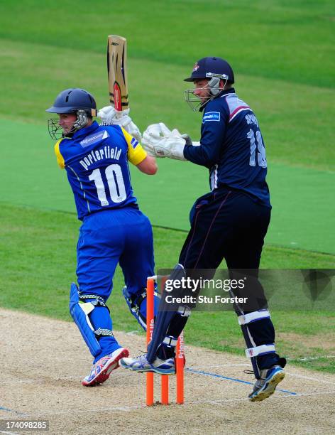 Northants keeper David Murphy looks on as Warwickshire batsman William Porterfield picks up some runs during the Friends Life T20 match between...