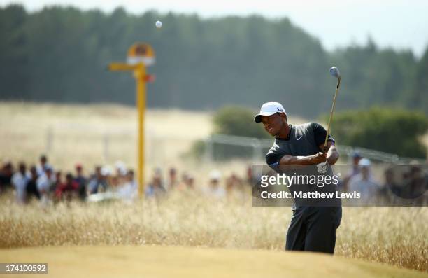 Tiger Woods of the United States hits a shot on the 5th during the third round of the 142nd Open Championship at Muirfield on July 20, 2013 in...