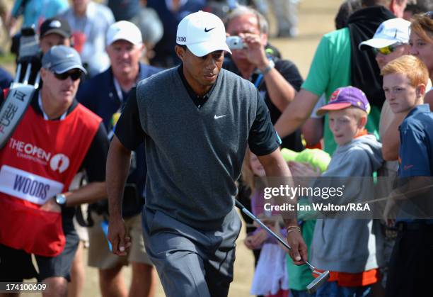 Tiger Woods of the United States walks through the crowd during the third round of the 142nd Open Championship at Muirfield on July 20, 2013 in...