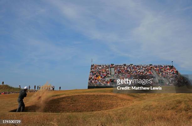 Tiger Woods of the United States plays out of a bunker on the fourth hole during the third round of the 142nd Open Championship at Muirfield on July...