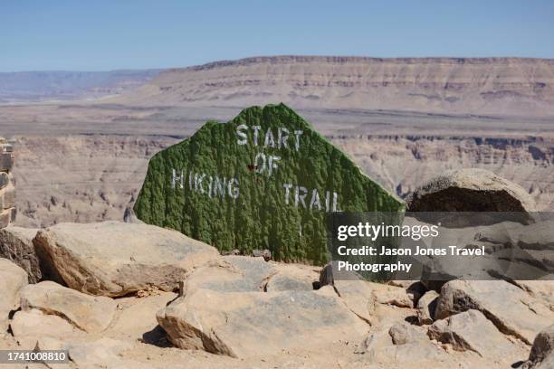 a stone sign marks the start of a hiking trail - namibian cultures stock pictures, royalty-free photos & images