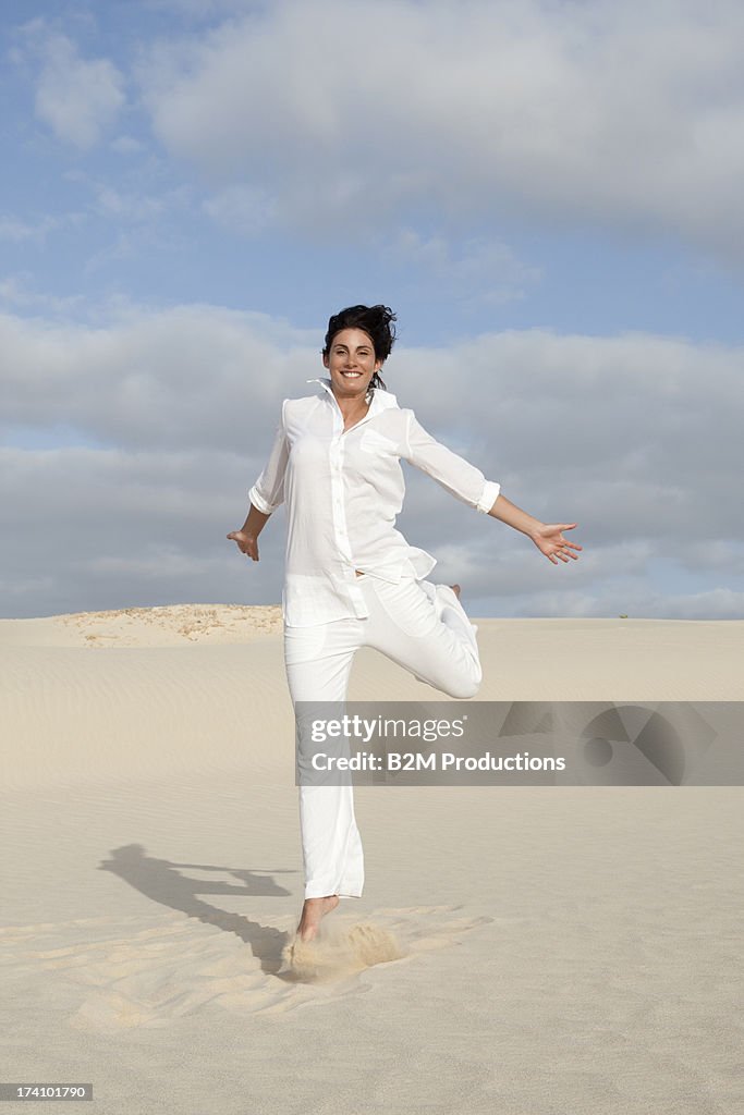 Young Happy Woman Running In Desert